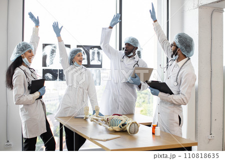 Group of medics celebrating success by raising their hands. Group of medics celebrating success by raising their hands. 110818635