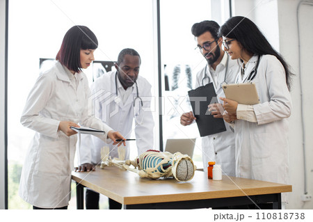 African man teacher teaching anatomy to university students or young doctors. African man teacher teaching anatomy to university students or young doctors. 110818738