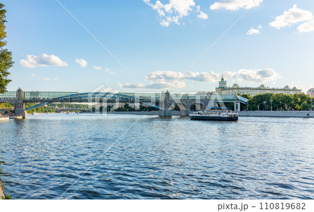 View of the Moscow river embakment, Pushkinsky bridge and cruise ships at sunset. View of the Moscow river embakment, Pushkinsky bridge and cruise ships at sunset. 110819682