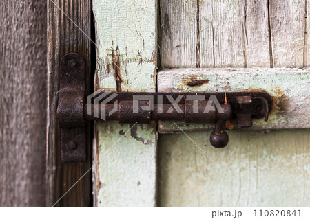 Closed old rusty door latch, closeup Closed old rusty door latch, closeup 110820841