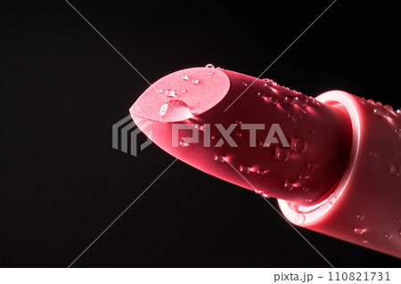 Red lipstick with water drops on a dark background. 110821731