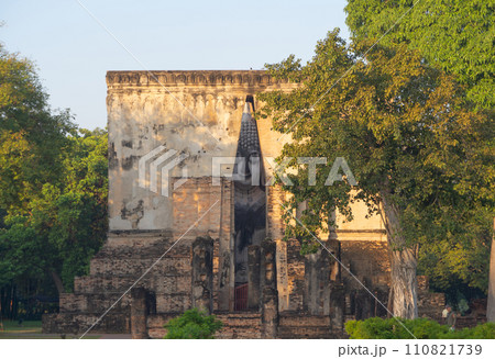The buddha in Wat Si Chum in Sukhothai Historical Park, pagoda stupa, Sukhothai, Thailand. Thai buddhist temple architecture. Tourist attraction. The buddha in Wat Si Chum in Sukhothai Historical Park, pagoda stupa, Sukhothai, Thailand. Thai buddhist temple architecture. Tourist attraction. 110821739