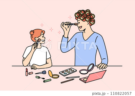 Mom and daughter do makeup together, preparing for family party, standing near table with cosmetics 110822057