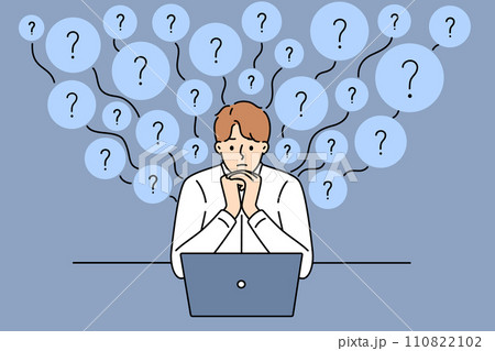 Thoughtful man answers user questions working in support service, sitting at table with laptop Thoughtful man answers user questions working in support service, sitting at table with laptop 110822102