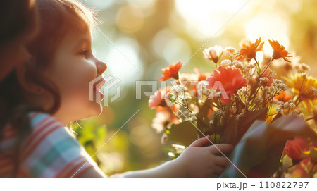 Emotions of a happy child with a bouquet in his hands. Emotions of a happy child with a bouquet in his hands. 110822797