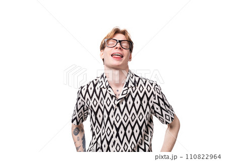 young european guy with red hair wears glasses for vision correction and shows tongue young european guy with red hair wears glasses for vision correction and shows tongue 110822964