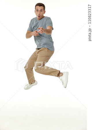 happy guy looking pointing at the camera on white studio background 110823317