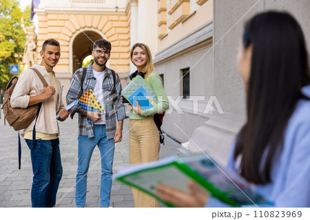 University students standing outdoor after classes. 110823969