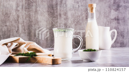 Ayran homemade yogurt drink with dill in a glass on the table web banner 110824157