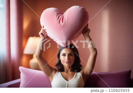 Happy young girl holding heart shaped pink pillow. Banner perfect for Valentines Day card, romantic themed design, voucher, greeting card, print. Concept love. Copy space. 110825035