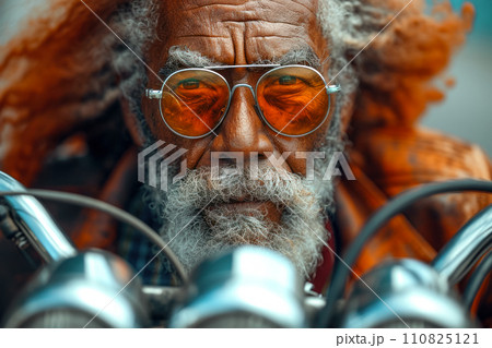 Portrait of an elderly African-American biker driving a chopper driving along the highway, the idea of freedom and travel, passion for new discoveries and contacts, motorcycle advertising Portrait of an elderly African-American biker driving a chopper driving along the highway, the idea of freedom and travel, passion for new discoveries and contacts, motorcycle advertising 110825121