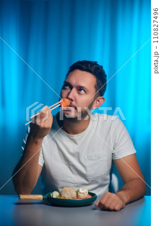 Unrecognizable man eating poke bowl with salmon,avocado,seaweed Unrecognizable man eating poke bowl with salmon,avocado,seaweed 110827496