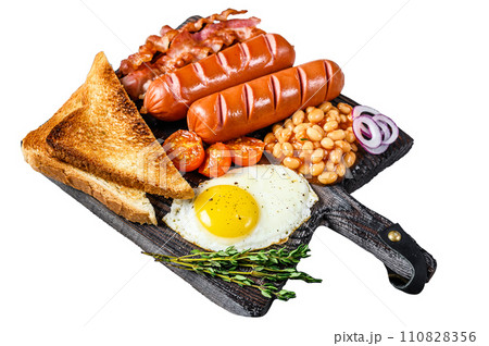 Full fry up English breakfastt with fried eggs, sausages, bacon, beans and toasts on a wooden cutting board. Isolated on white background, Top view. 110828356