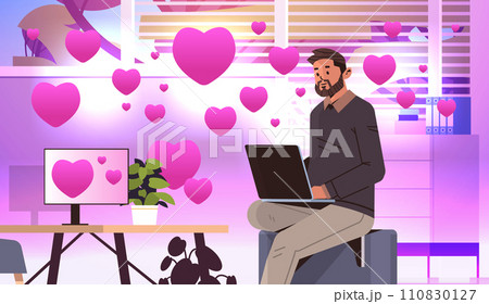 man in love using laptop social media communication happy valentines day celebration concept living room interior with pink hearts 110830127