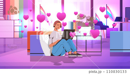 girl in love using laptop social media communication happy valentines day celebration concept living room interior with pink hearts 110830133