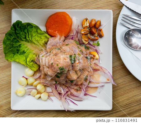 Seafood ceviche from hake with onion and vegetables 110831491