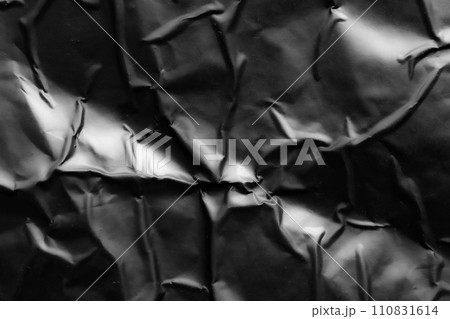 black crumpled and creased plastic poster texture background 110831614