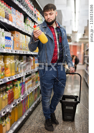 Man purchasing sweet soft drinks 110831686