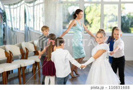 Children holding hands and dancing in round dance - festive pastime Children holding hands and dancing in round dance - festive pastime 110831688