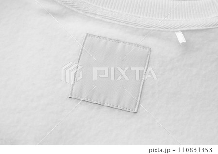 Blank white laundry care clothes label on fabric texture background 110831853