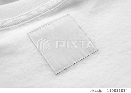 Blank white laundry care clothes label on fabric texture background Blank white laundry care clothes label on fabric texture background 110831854