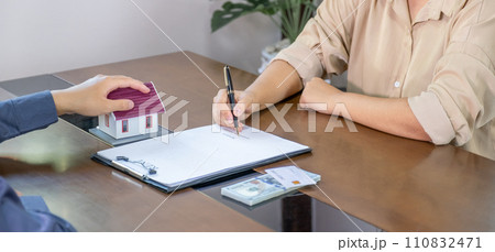 Real estate agents and buyers discuss signing a business contract, renting, buying, mortgage, loan or home insurance 110832471