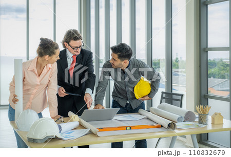 Engineer team is meeting to inspect the construction blueprint drawings, work plan and distribute work before starting the building Engineer team is meeting to inspect the construction blueprint drawings, work plan and distribute work before starting the building 110832679