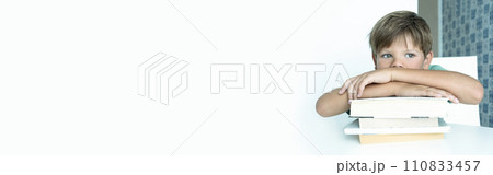 Banner. Sad boy with textbook does school homework. Back to school.  schoolboy. Distance learning. 110833457