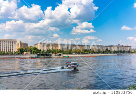 View of the Ministry of Defence of Russian Federation, and Moscow river embakment with cruise ships at sunset. 110833756