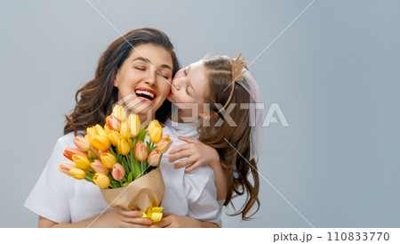 Daughter and mother with bouquet of flowers 110833770