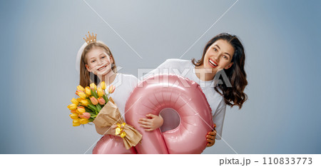 Daughter and mother with bouquet of flowers Daughter and mother with bouquet of flowers 110833773