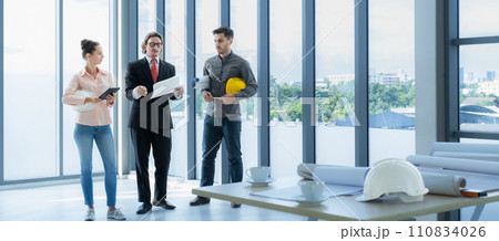 Engineer team meeting to inspect the construction blueprint drawings, work plan and distribute work before starting the building Engineer team meeting to inspect the construction blueprint drawings, work plan and distribute work before starting the building 110834026