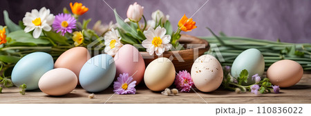 Multicolored Easter eggs on the table with spring flowers - Easter banner with a space for text. AI generated 110836022