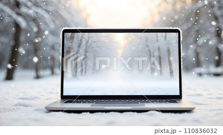 Laptop with with winter landscape wallpaper in outdoor in the snow with a cozy blanket in a snowfall. Seasonal remote work, internet, shopping, Christmas and New Year, banner. AI generated 110836032