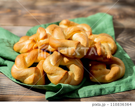 Taralli twist on wooden background. Typical italian ring-shaped or doughnut-shaped biscuit cookies or appetizers for wine Taralli or Taralle. Copy space 110836364
