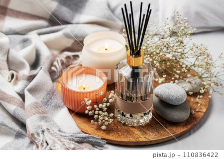 Cozy home atmosphere. Home liquid fragrance in glass bottle Cozy home atmosphere. Home liquid fragrance in glass bottle 110836422