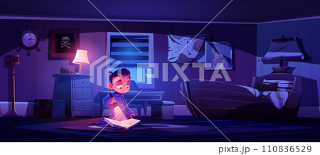 Little boy in bedroom at night reading book 110836529