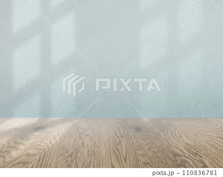 緑の壁とナチュラルで茶色い木目の床の背景画像素材、淡い影が入った壁とフローリングのバックグラウンド 110836781