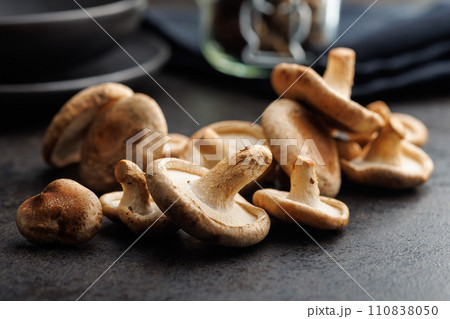 The fresh shiitake mashrooms on black table. 110838050