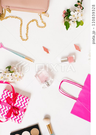 Concept of a beauty blog. Accessories for women's makeup and delicate apple blossoms on a white background. Flat apartment, top view, women's desk, workplace 110839328