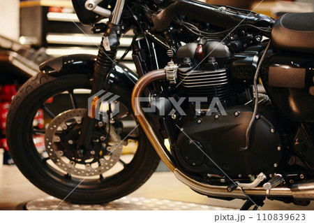 Cropped image of motorcycle in modern garage of repairman 110839623