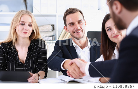 Smiling man in suit shake hands as hello 110839867
