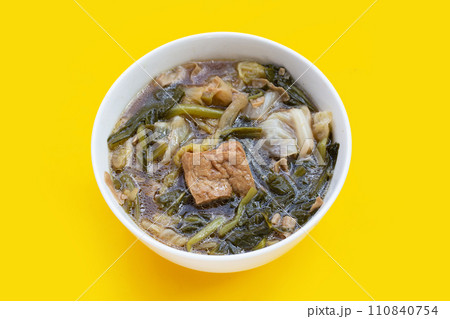 Mixed vegetable stew with tofu in white bowl (Tom Jub Chai) 110840754