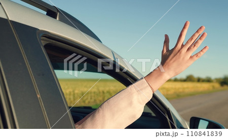 girl rides car with her hand out window, young happy carefree woman, opens window, happy family, cheerful girl smiling, enjoying picturesque landscape sunset, sun glare sunset driver hand leans out girl rides car with her hand out window, young happy carefree woman, opens window, happy family, cheerful girl smiling, enjoying picturesque landscape sunset, sun glare sunset driver hand leans out 110841839