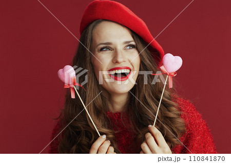 happy elegant female in red sweater and beret 110841870
