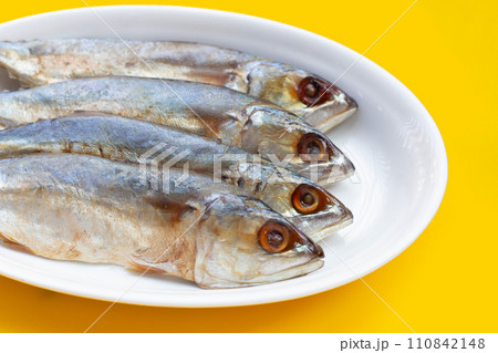 Salted fish on yellow background. 110842148