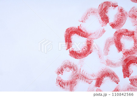 Imprint of a kiss on a letter on a gray background. 110842566