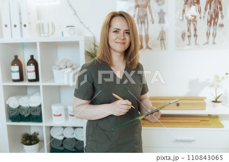 happy female massage therapist in massage cabinet happy female massage therapist in massage cabinet 110843065