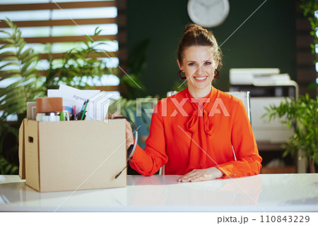 happy 40 years old woman employee in green office happy 40 years old woman employee in green office 110843229