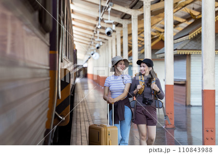 two young beautiful female women at station to catch train for their vacation together 110843988
